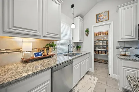 a kitchen with a sink cabinets and window