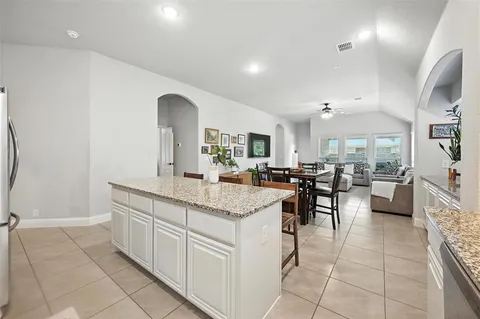 a kitchen with stainless steel appliances granite countertop a sink stove and microwave