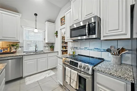 a kitchen with stainless steel appliances granite countertop a sink counter space cabinets and a counter top space