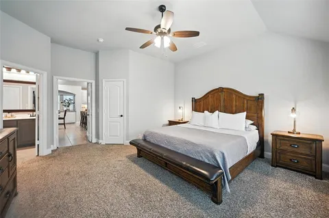 a bedroom with a bed and a chandelier