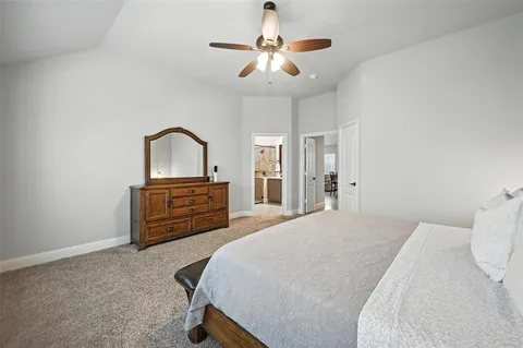 a bedroom with a bed dresser and a window