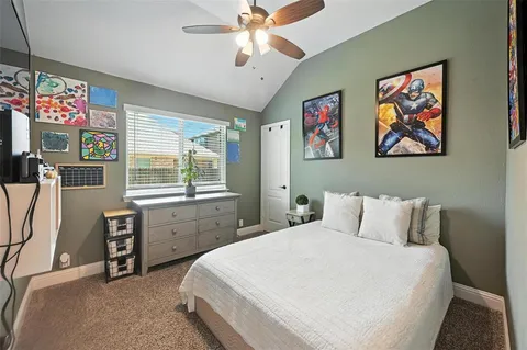 a bedroom with a bed and a desk