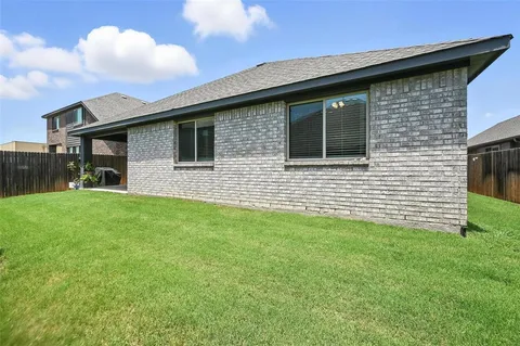 a brick house with a yard