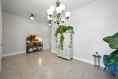 a view of a room with natural light and potted plants