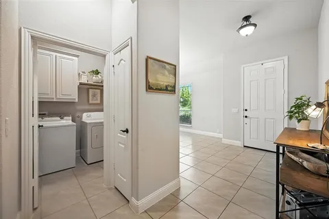 a view of kitchen with white cabinets and stainless steel appliances