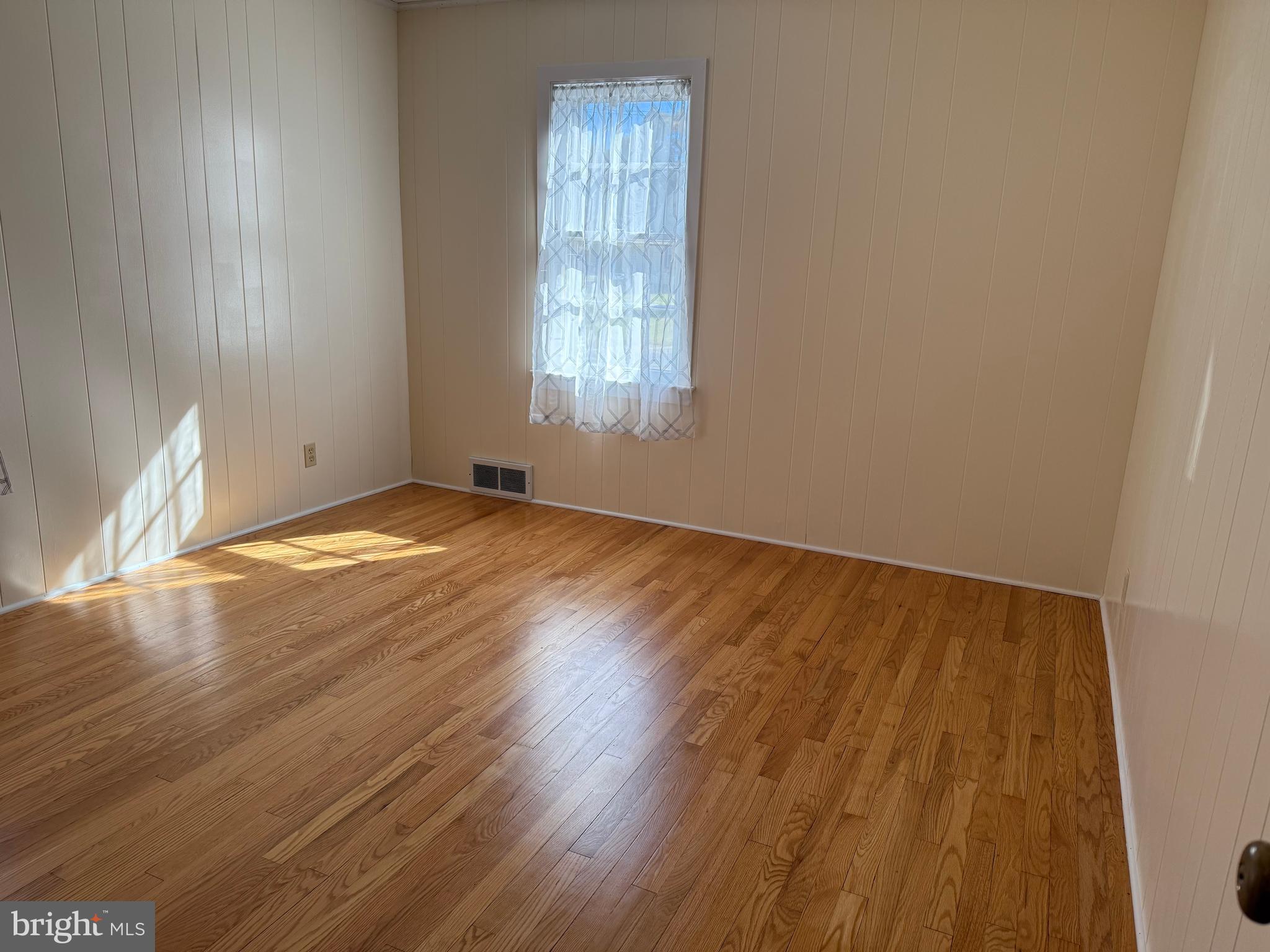 34 Townsend Avenue Bridgeton, NJ 08302 - Photo 19 of 23 an empty room with wooden floor and windows