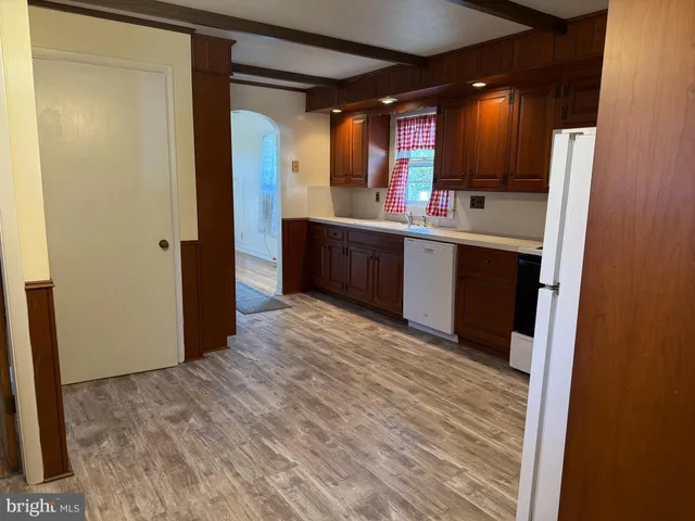 a view of kitchen with refrigerator sink and wooden floor