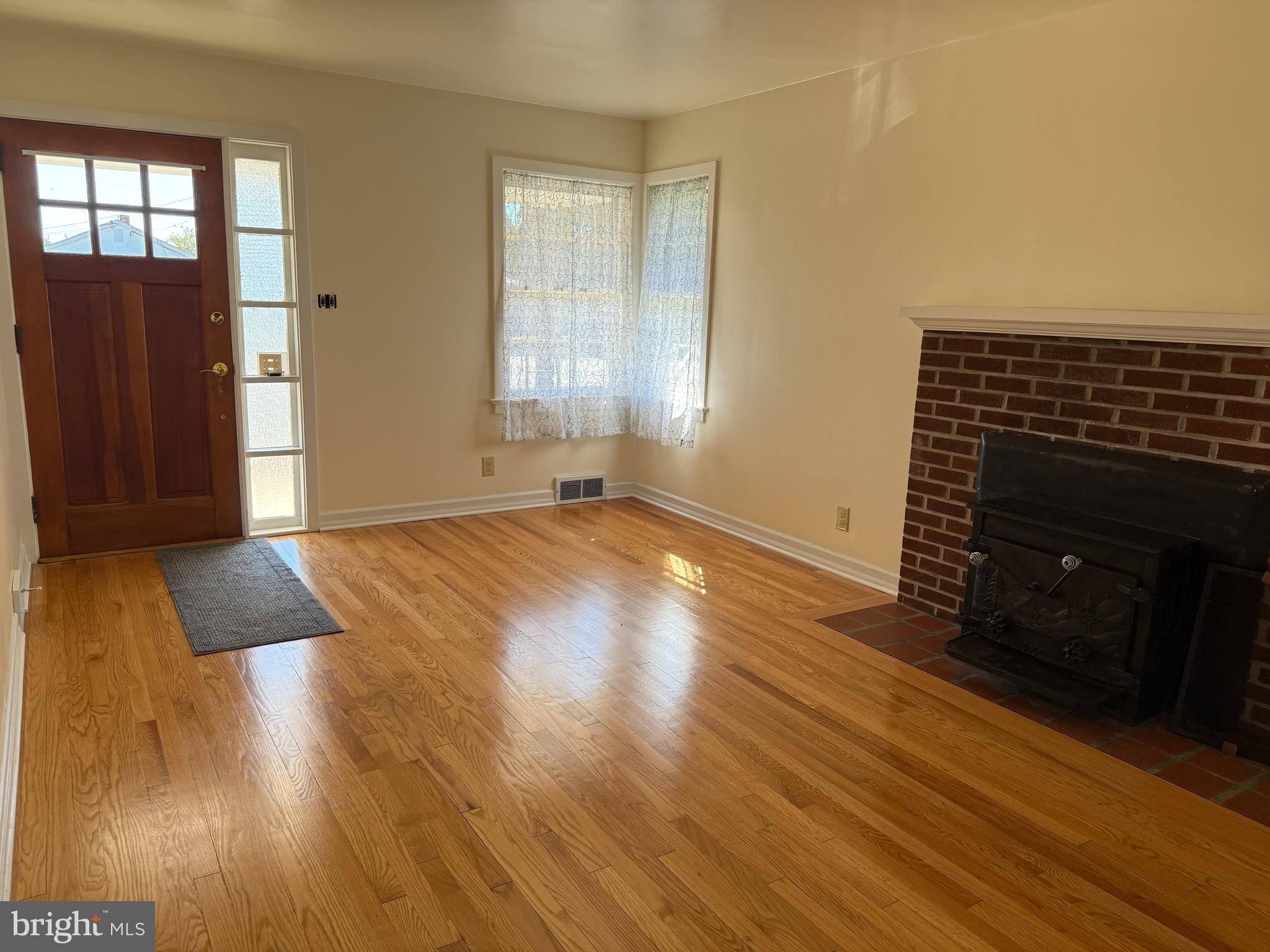 34 Townsend Avenue Bridgeton, NJ 08302 - Photo 8 of 23 a view of an empty room with wooden floor and a window