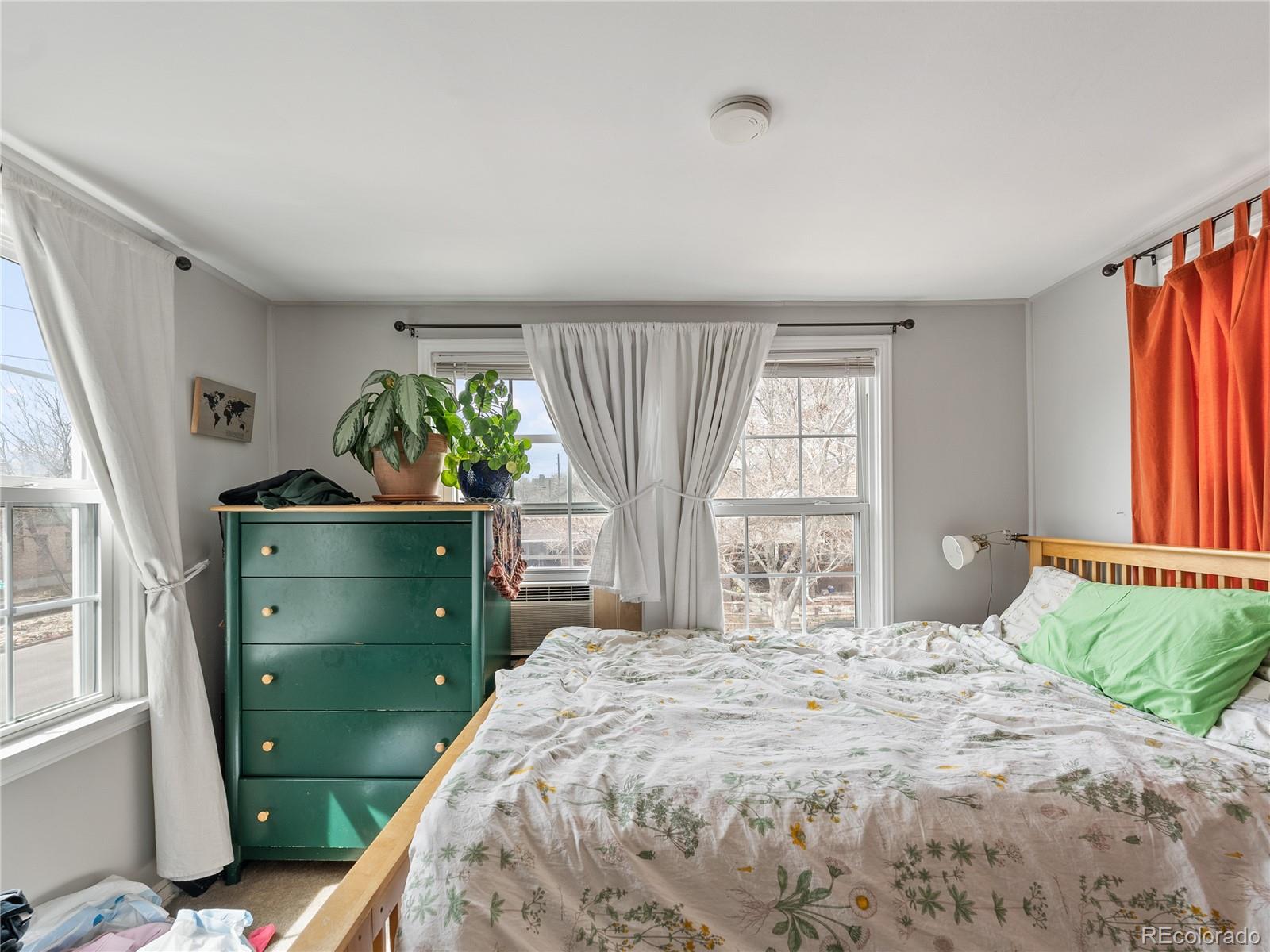 Undisclosed Address Denver, CO 80206 - Photo 11 of 33 a bedroom with a bed and a window