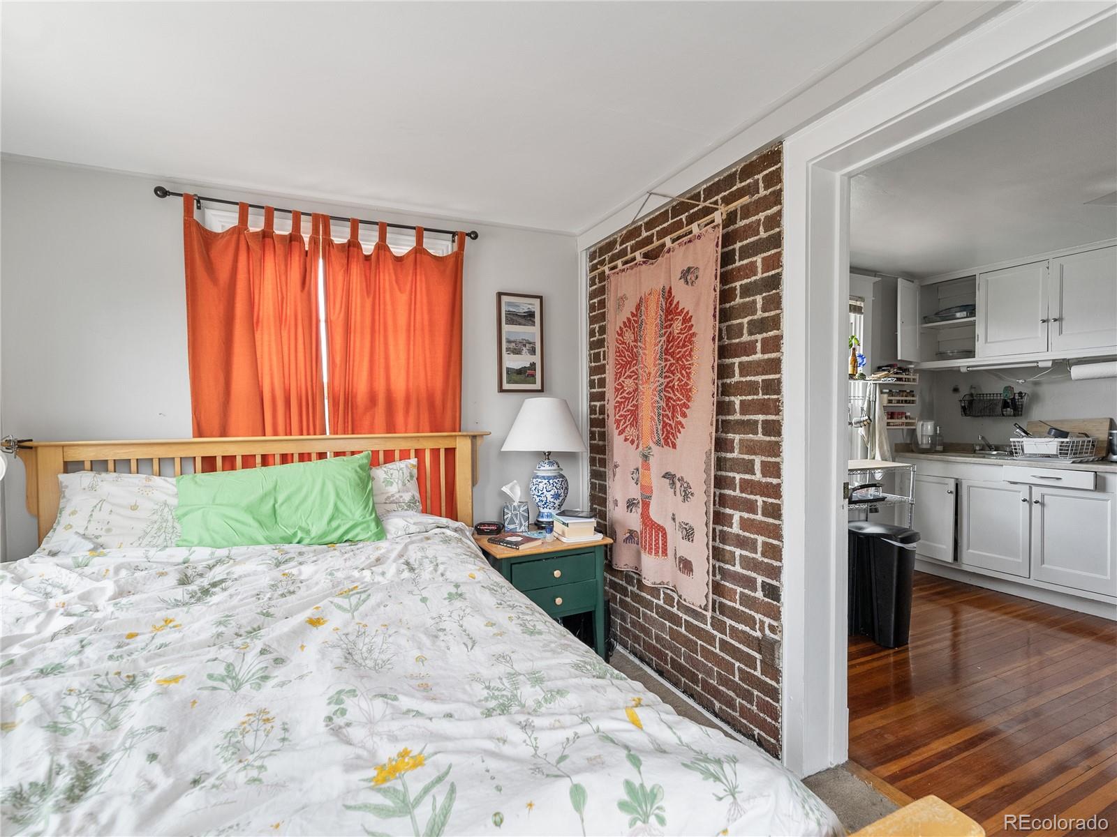 Undisclosed Address Denver, CO 80206 - Photo 12 of 33 a kitchen with stainless steel appliances kitchen island granite countertop a refrigerator and a sink