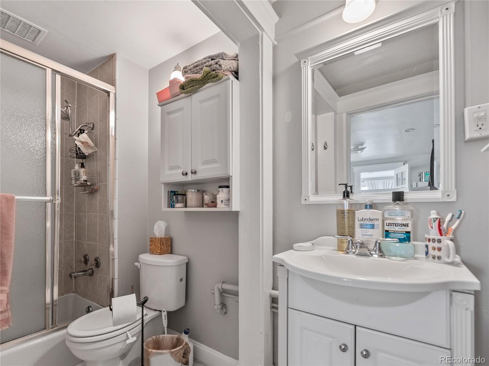 Undisclosed Address Denver, CO 80206 - Photo 14 of 33 a bathroom with a sink a toilet and shower