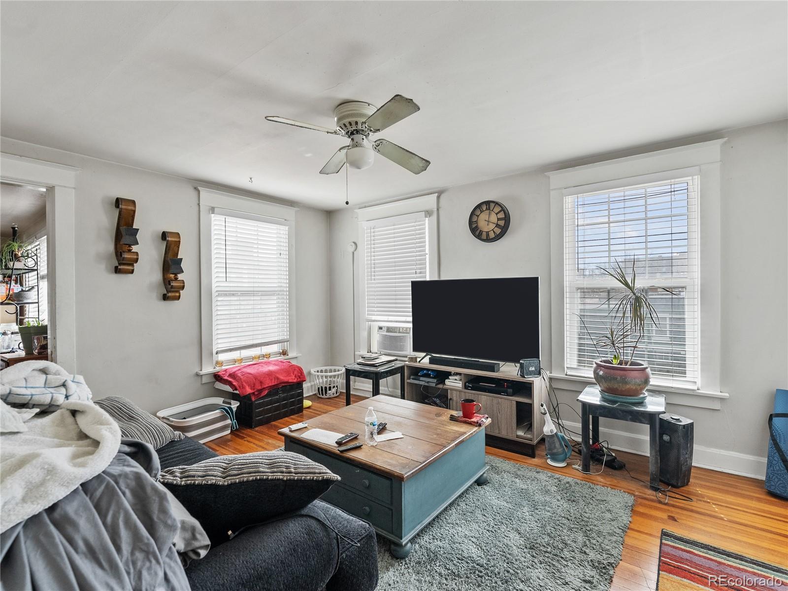 Undisclosed Address Denver, CO 80206 - Photo 17 of 33 a living room with furniture and a flat screen tv