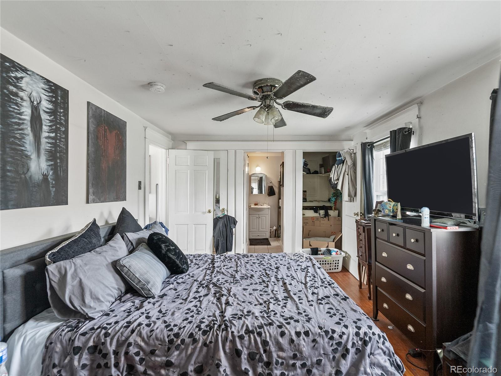 Undisclosed Address Denver, CO 80206 - Photo 19 of 33 a bedroom with a bed and a flat screen tv