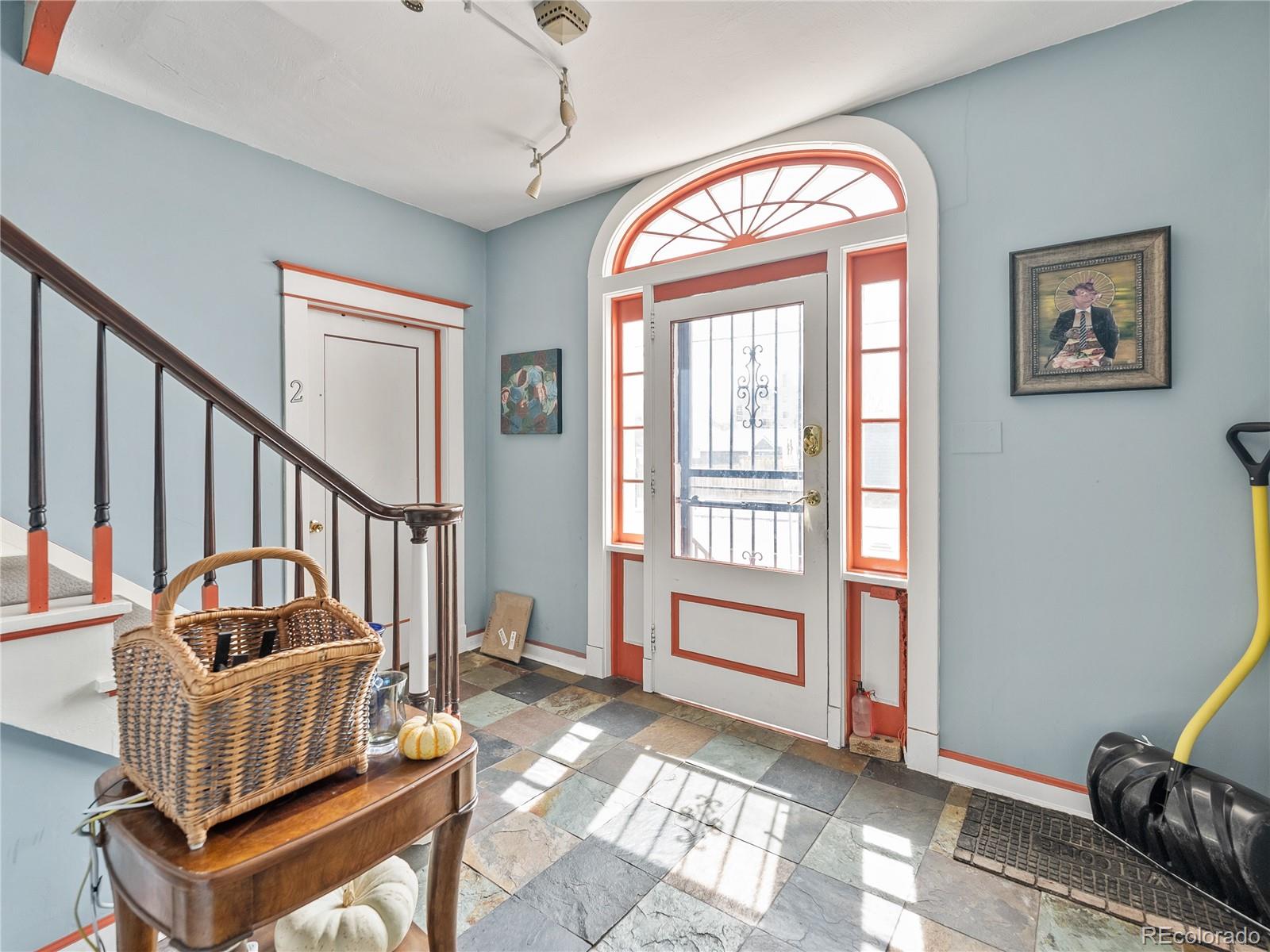 Undisclosed Address Denver, CO 80206 - Photo 2 of 33 a view of an entryway with wooden floor and windows