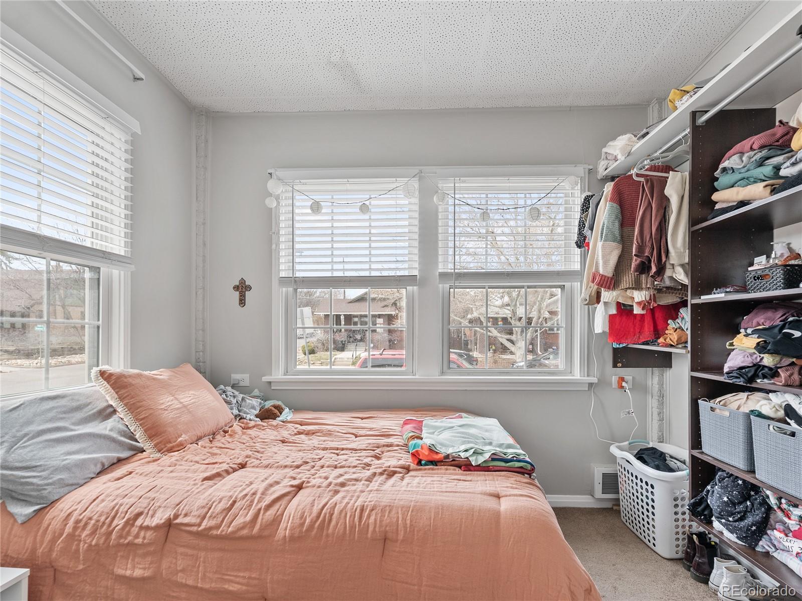 Undisclosed Address Denver, CO 80206 - Photo 23 of 33 a bedroom with furniture and a flat screen tv