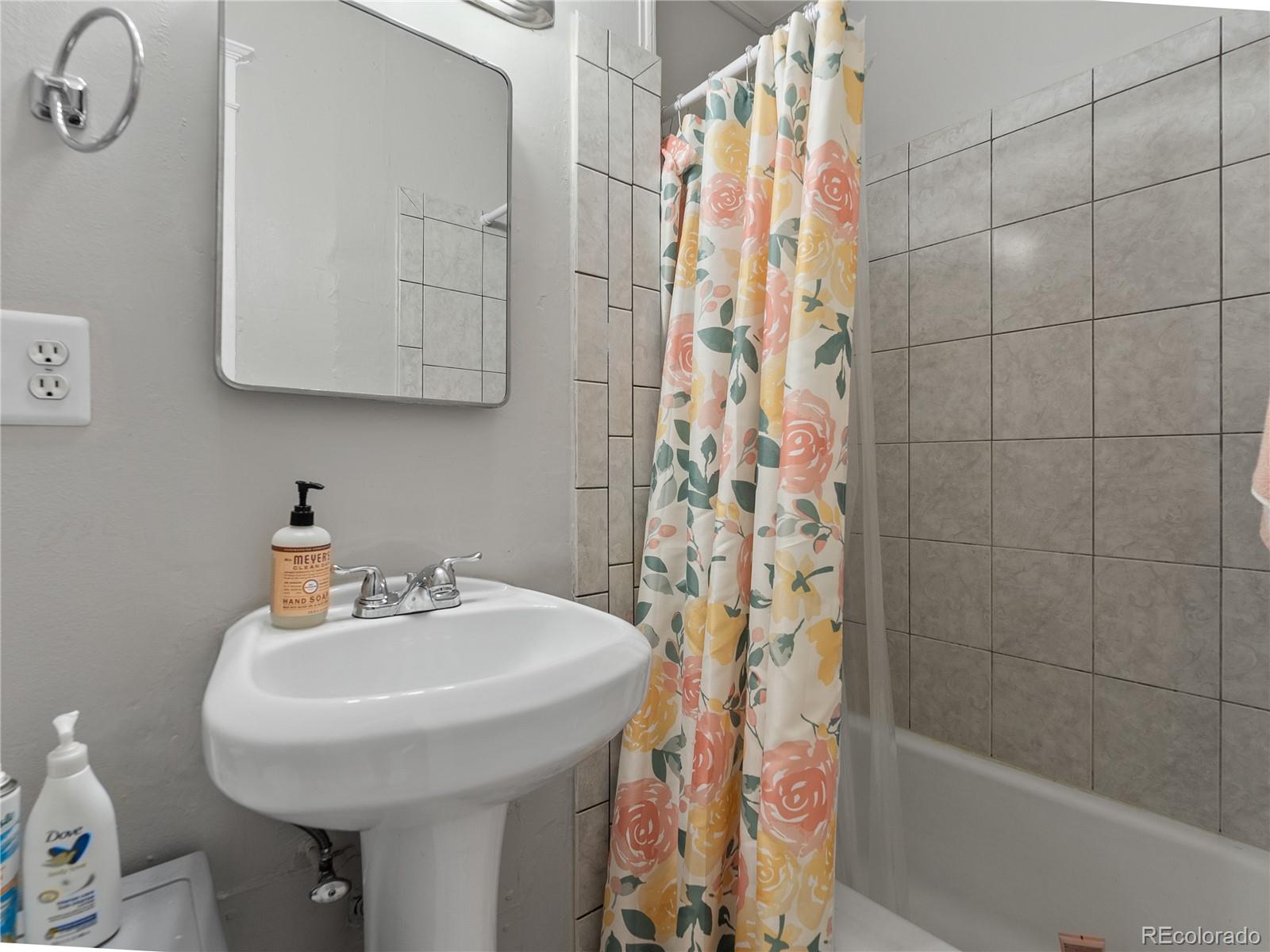 Undisclosed Address Denver, CO 80206 - Photo 25 of 33 a bathroom with a sink a toilet and shower