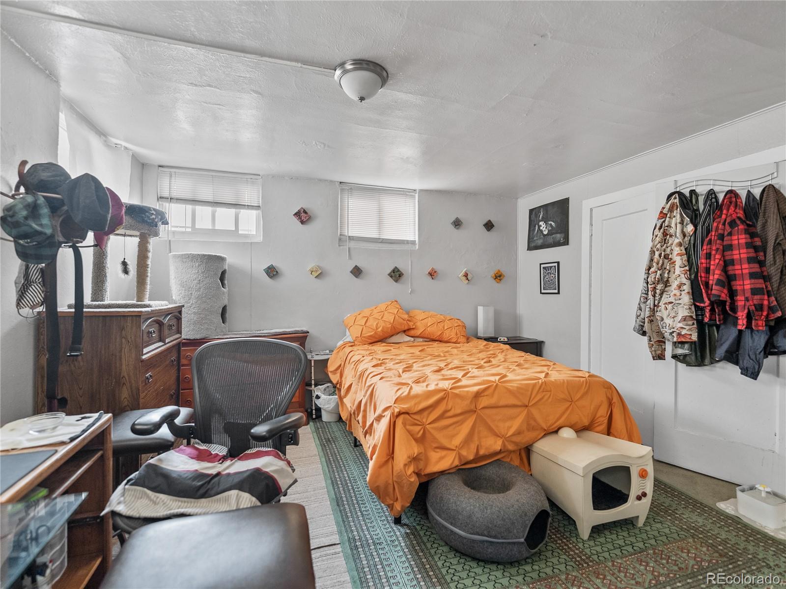 Undisclosed Address Denver, CO 80206 - Photo 27 of 33 a bed room with a bed and a chair