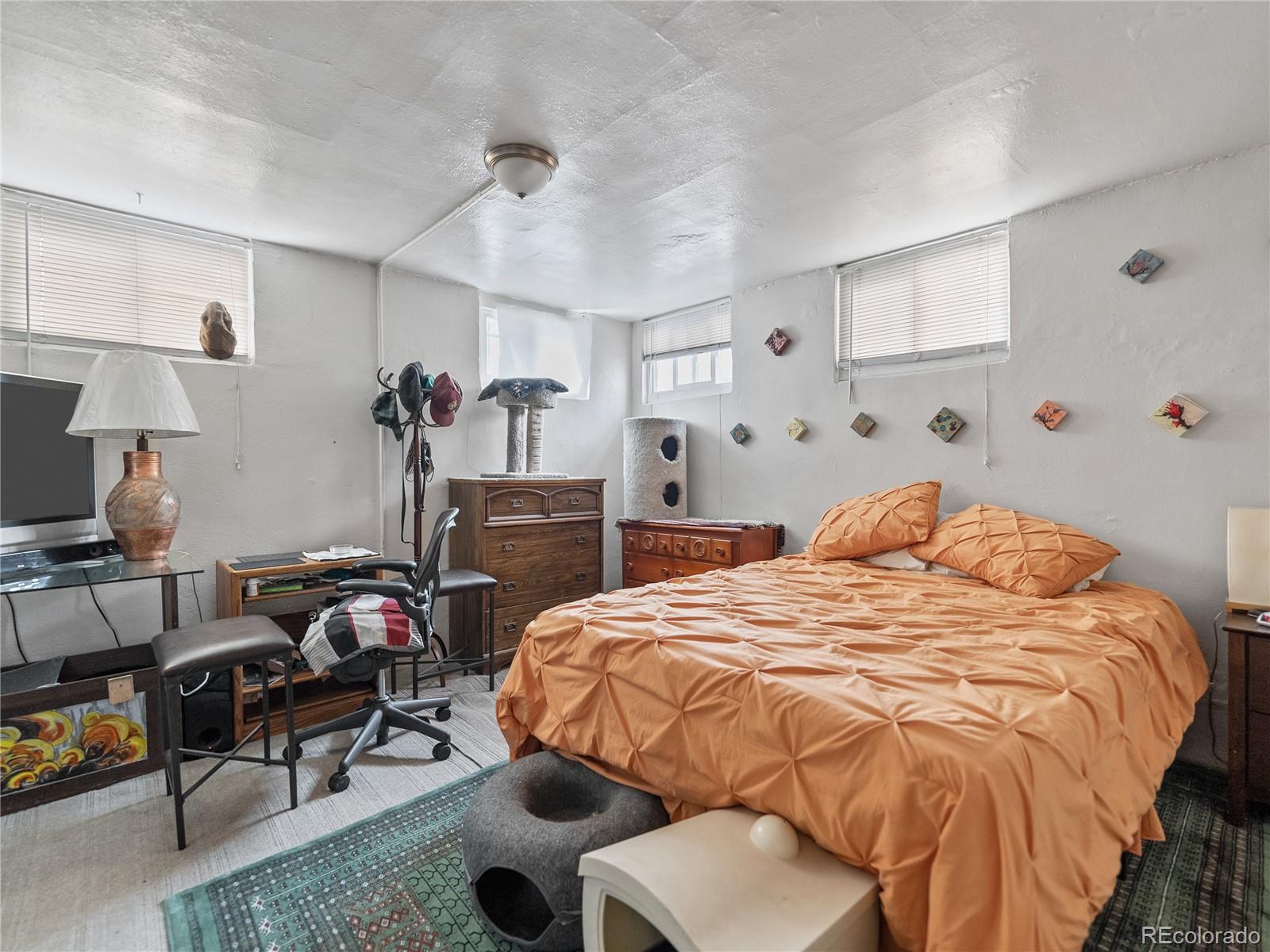 Undisclosed Address Denver, CO 80206 - Photo 28 of 33 a bedroom with bed and a closet