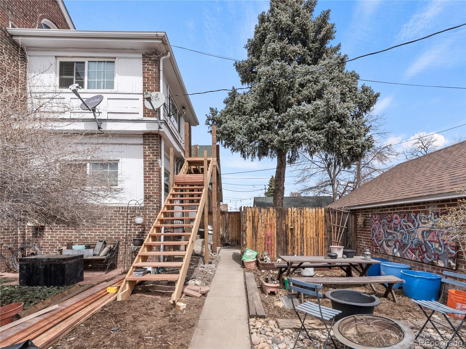 Undisclosed Address Denver, CO 80206 - Photo 31 of 33 a car parked beside a road next to a building