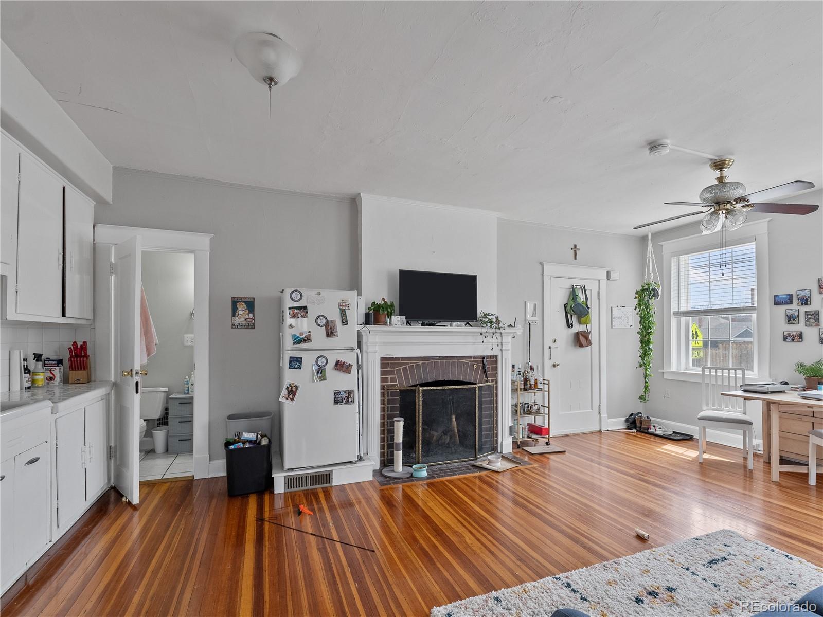Undisclosed Address Denver, CO 80206 - Photo 5 of 33 a living room with furniture fireplace and flat screen tv