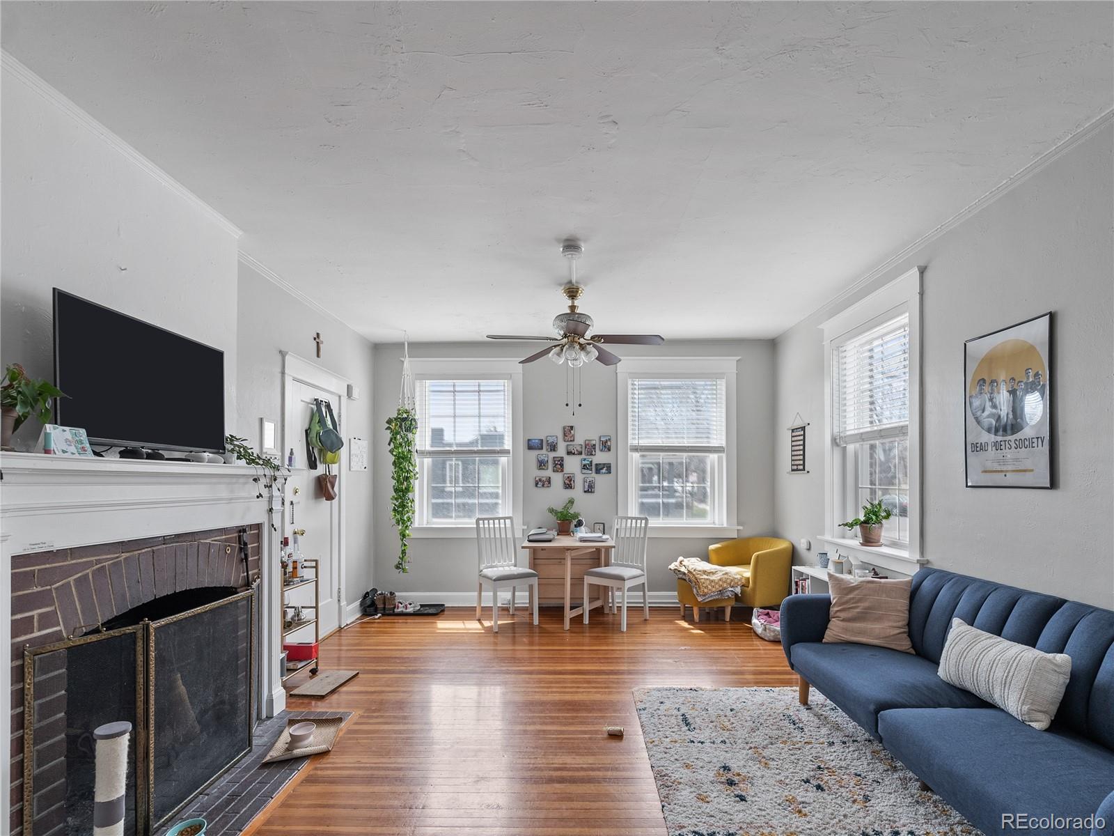 Undisclosed Address Denver, CO 80206 - Photo 6 of 33 a living room with furniture a flat screen tv and a fireplace