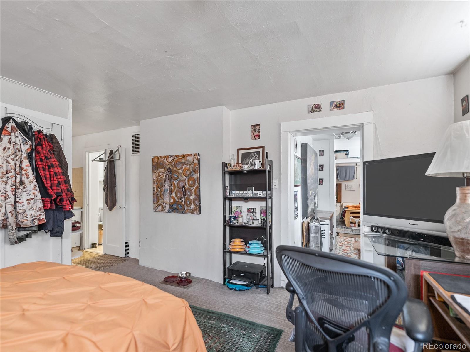 Undisclosed Address Denver, CO 80206 - Photo 8 of 33 a bedroom with a bed and a desk