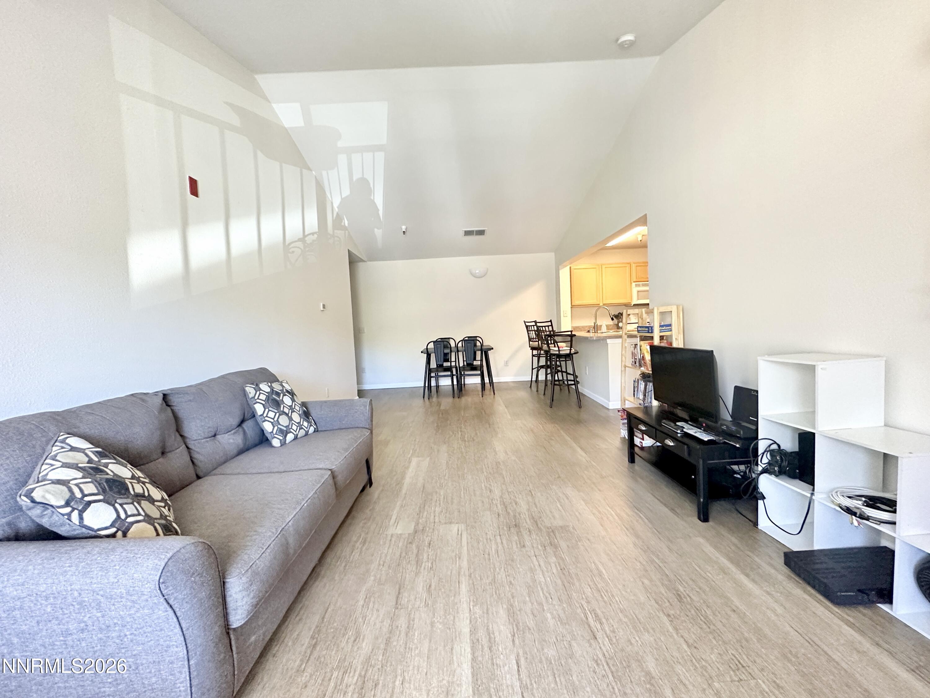 200 Talus Way, Unit 434 Reno, NV 89503 - Photo 3 of 21 a living room with furniture and a wooden floor