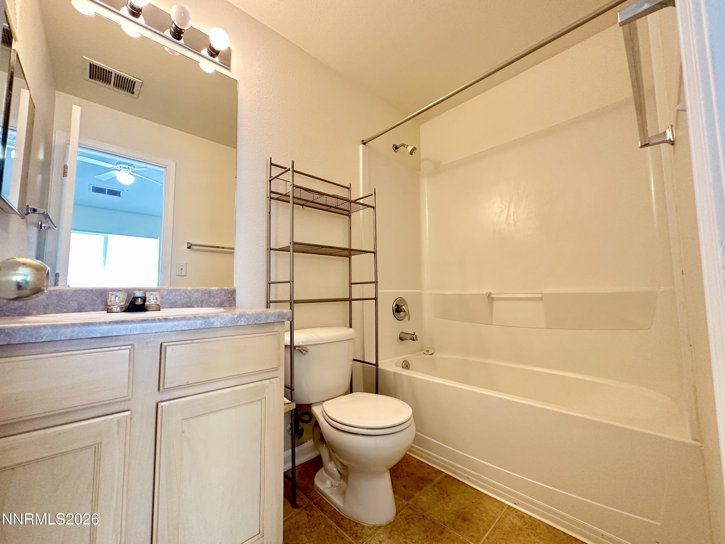 200 Talus Way, Unit 434 Reno, NV 89503 - Photo 6 of 21 a bathroom with a toilet sink vanity and shower