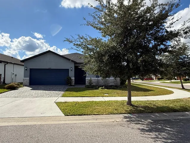 a front view of a house with a yard and garage