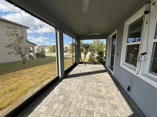 a view of a room with wooden floor and outdoor space