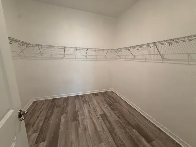 a view of a room with wooden floor