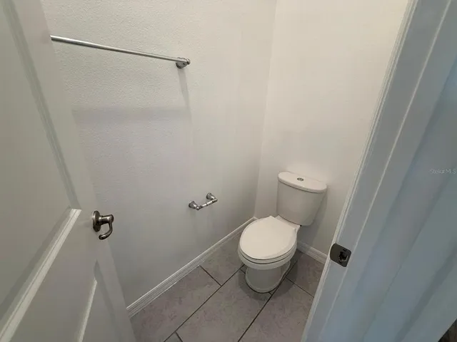 a white toilet sitting next to a shower