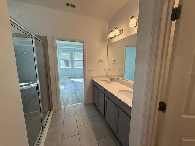 a bathroom with a granite countertop sink and mirror