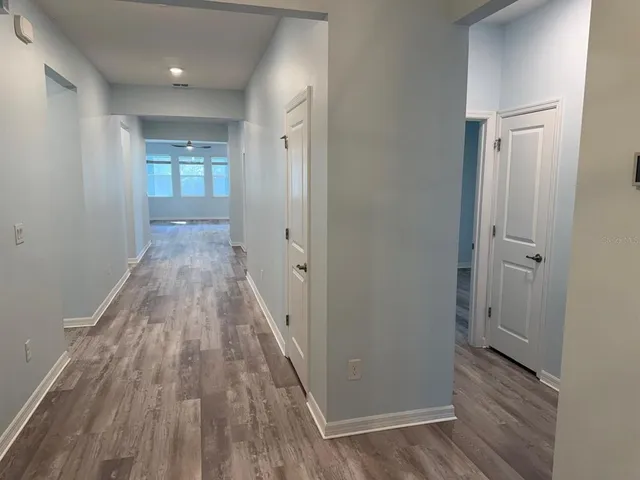 a view of a room with wooden floor and a bathroom