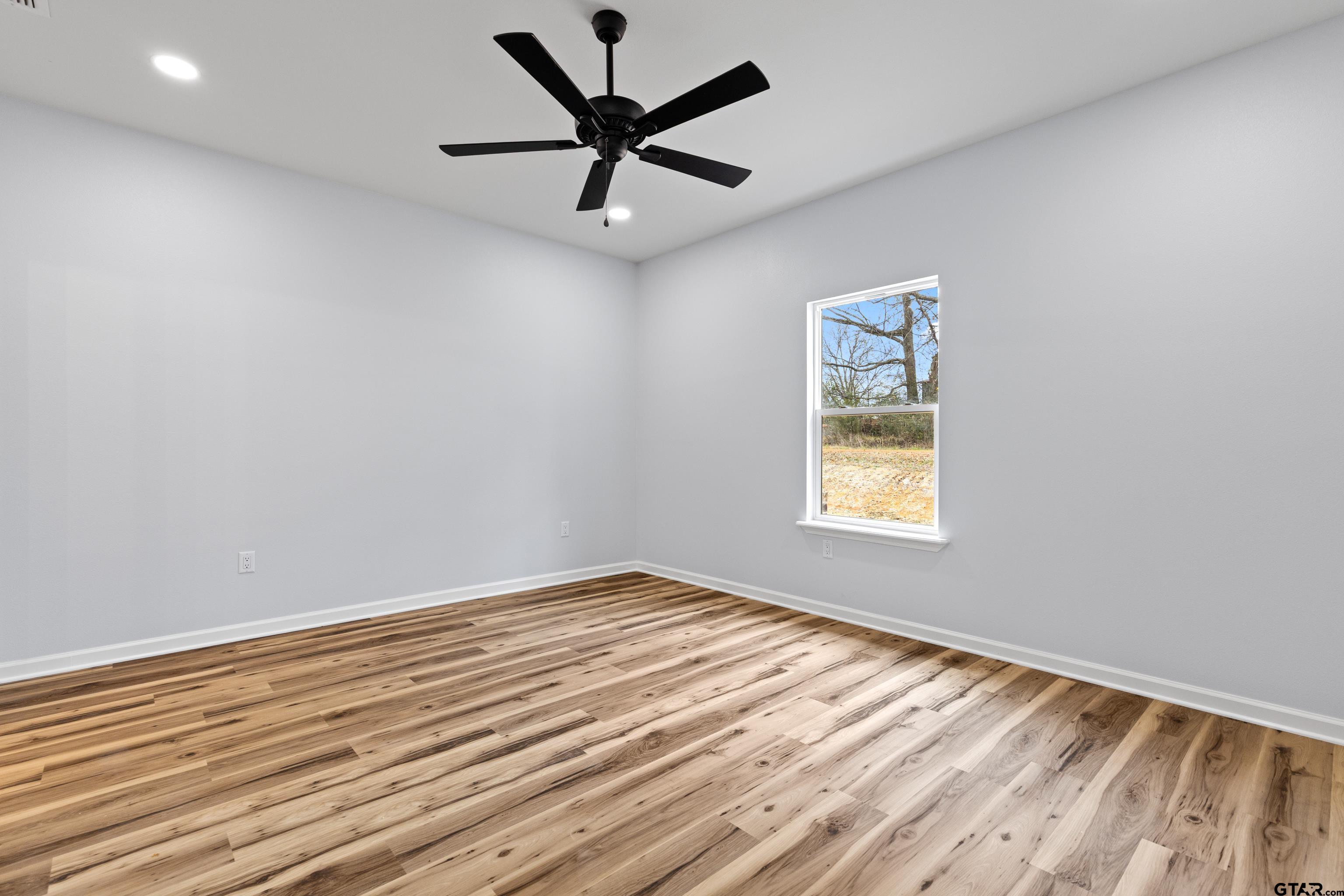 9934 Bob O Link Road Gladewater, TX 75647 - Photo 20 of 37 an empty room with a window and a ceiling fan