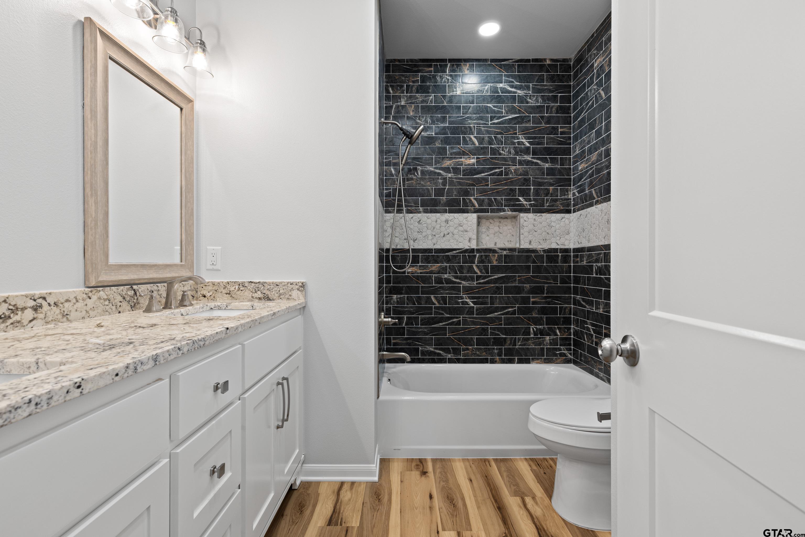 9934 Bob O Link Road Gladewater, TX 75647 - Photo 23 of 37 a bathroom with a granite countertop sink toilet and shower