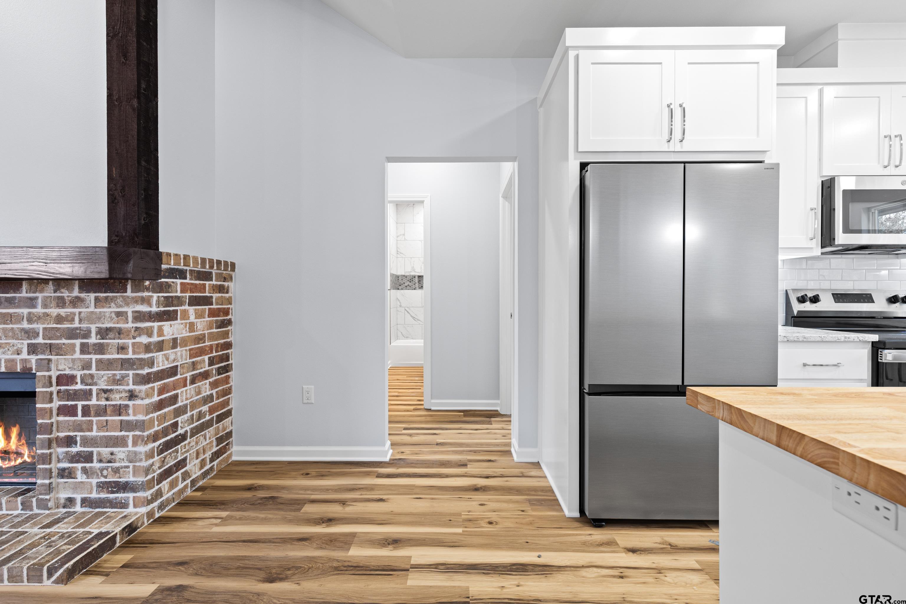 9934 Bob O Link Road Gladewater, TX 75647 - Photo 26 of 37 a view of a refrigerator in kitchen and wooden floor