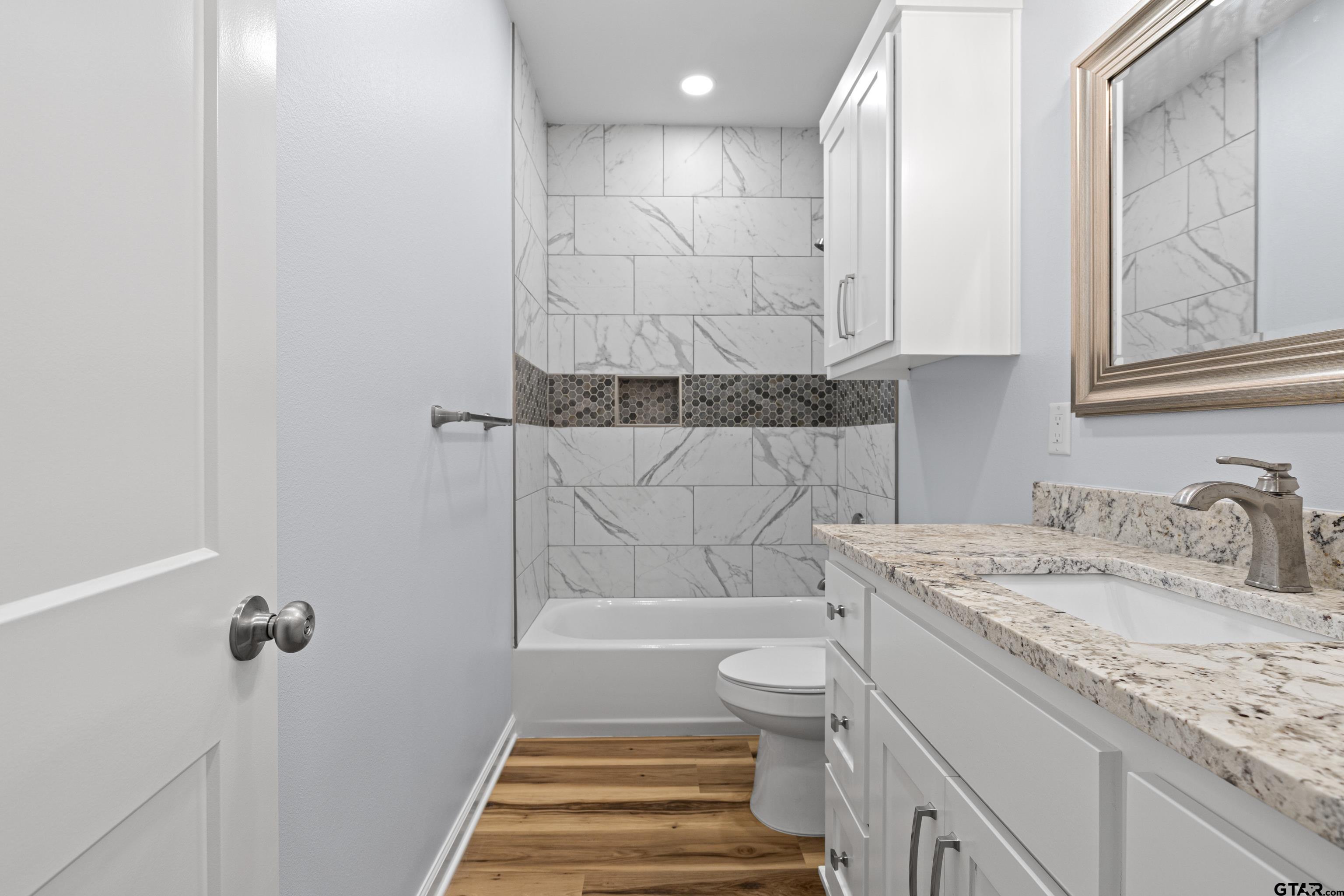 9934 Bob O Link Road Gladewater, TX 75647 - Photo 29 of 37 a bathroom with a granite countertop sink toilet and shower