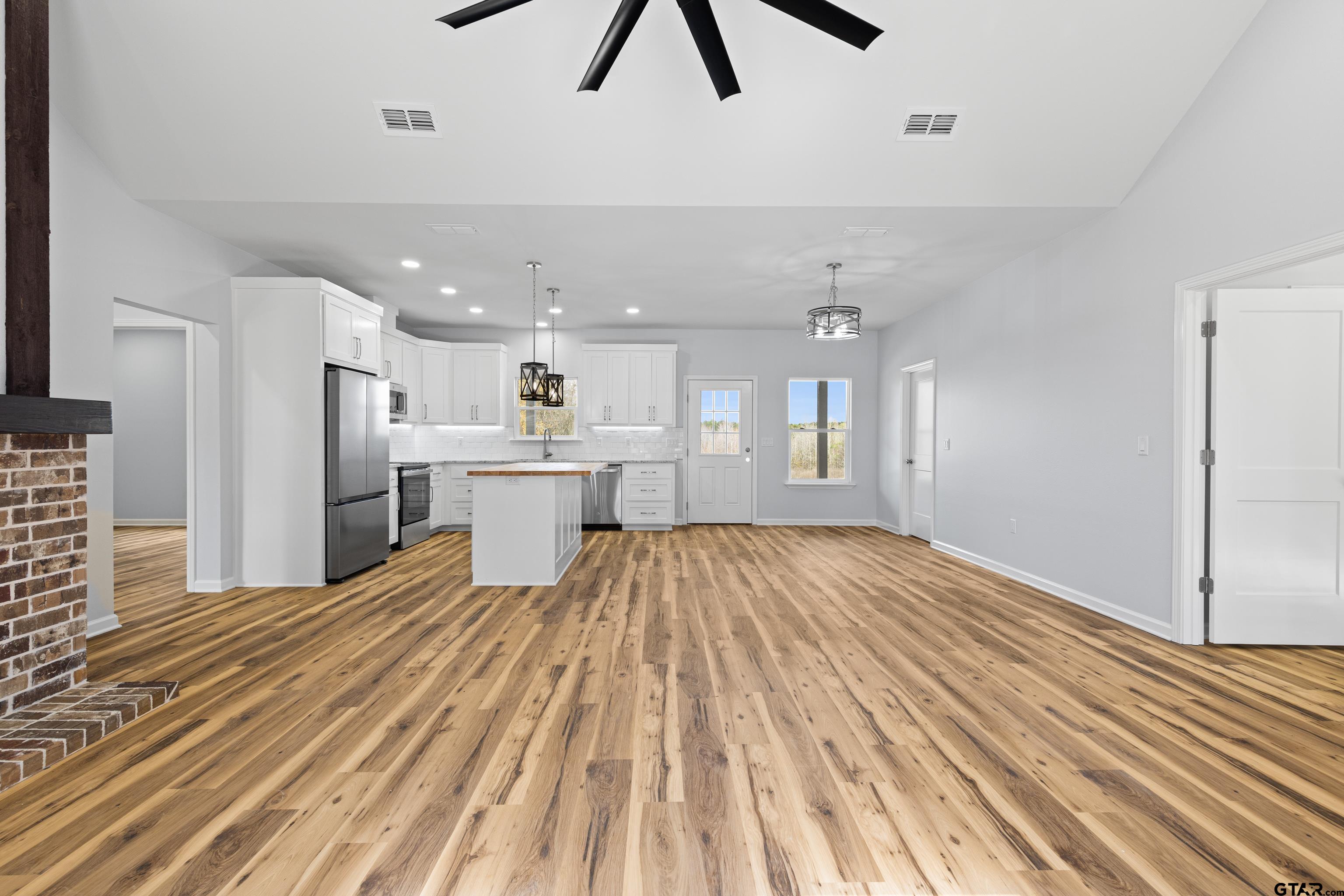 9934 Bob O Link Road Gladewater, TX 75647 - Photo 10 of 37 a view of kitchen and empty room with wooden floor