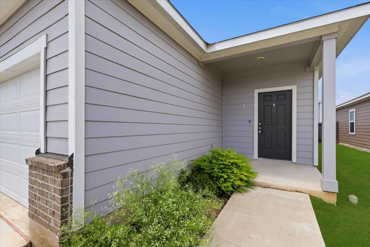202 Peridot Pass Maxwell, TX 78656 - Photo 2 of 21 A welcoming covered porch and fresh landscaping enhance this home's curb appeal.