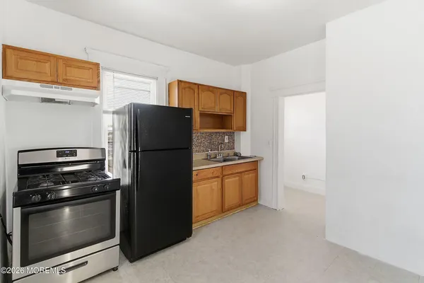 a kitchen with stainless steel appliances a refrigerator and a stove top oven