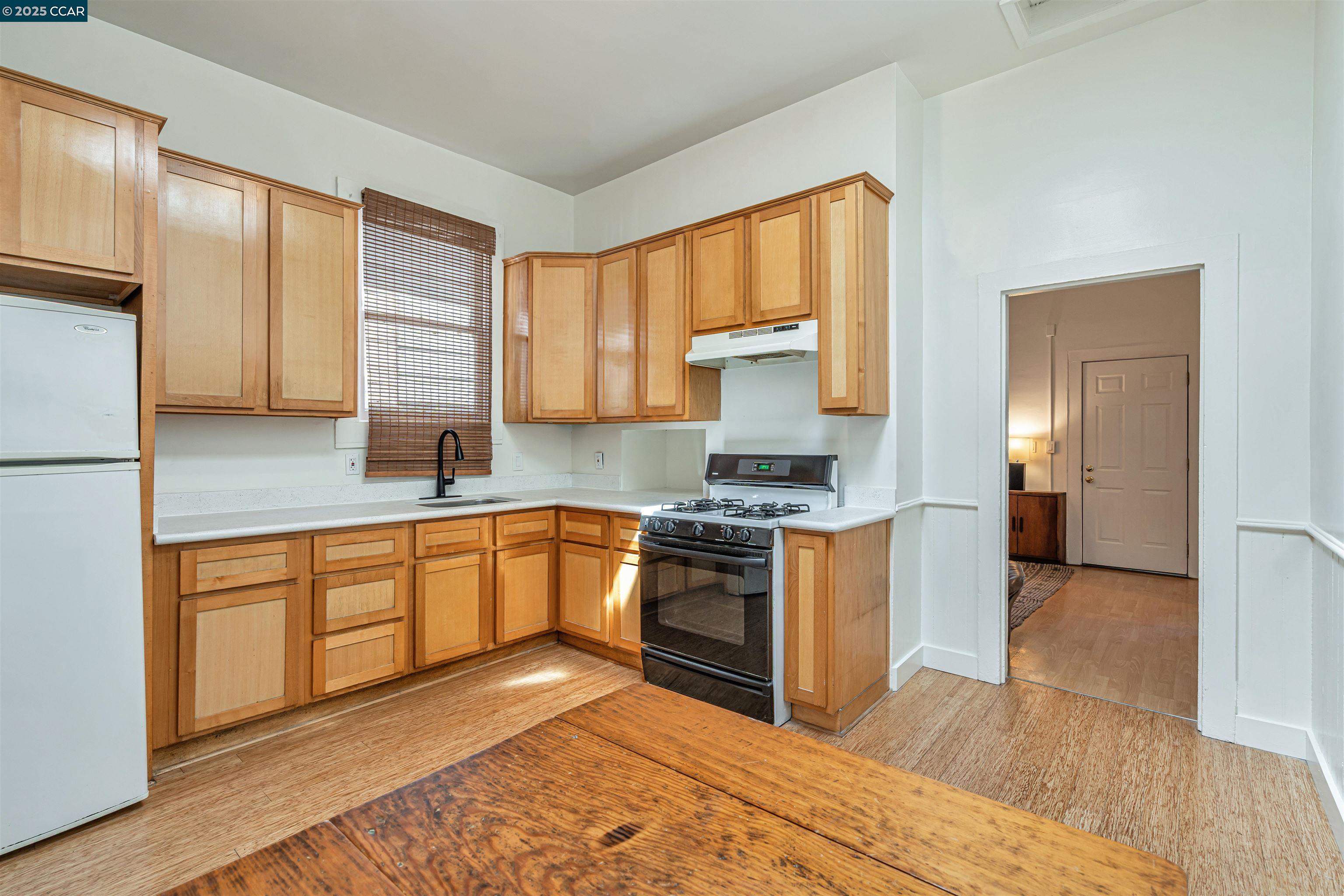 a kitchen with stainless steel appliances granite countertop a stove a sink and a refrigerator