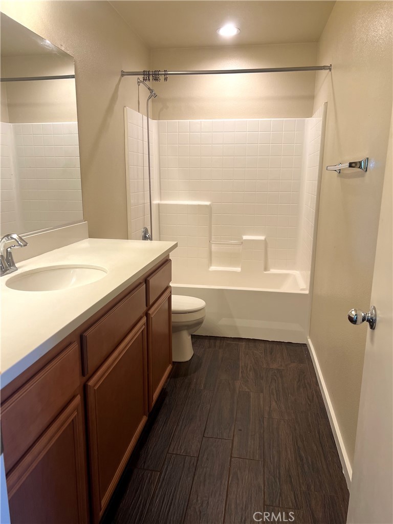 15765 Gable Street Victorville, CA 92394 - Photo 11 of 12 a bathroom with a sink a toilet a mirror and shower
