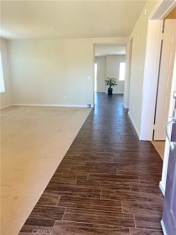 a view of a hallway view with wooden floor and staircase