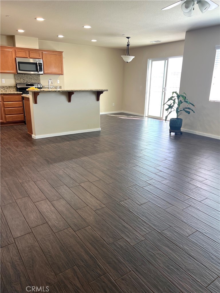 15765 Gable Street Victorville, CA 92394 - Photo 4 of 12 a view of kitchen with cabinets and wooden floor