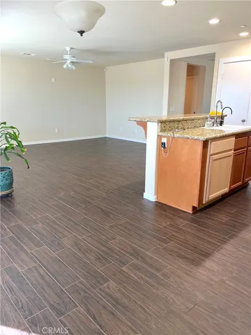 a room with wooden floor and cabinetry