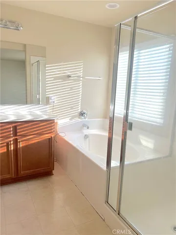 a spacious bathroom with a bathtub and a shower