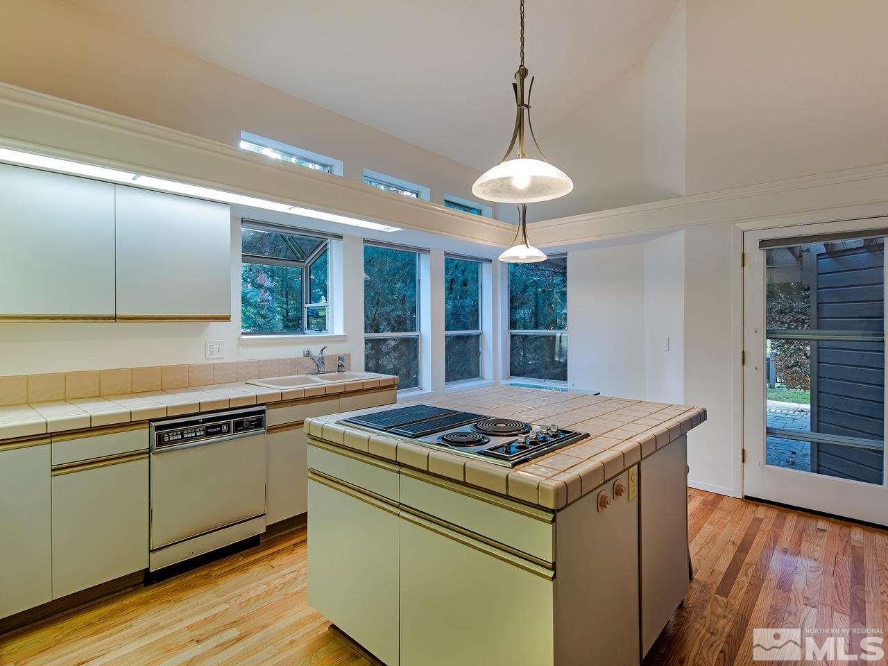 3975 Caughlin Creek Road Reno, NV 89519 - Photo 8 of 15 a kitchen that has a sink stainless steel appliances and wooden floor