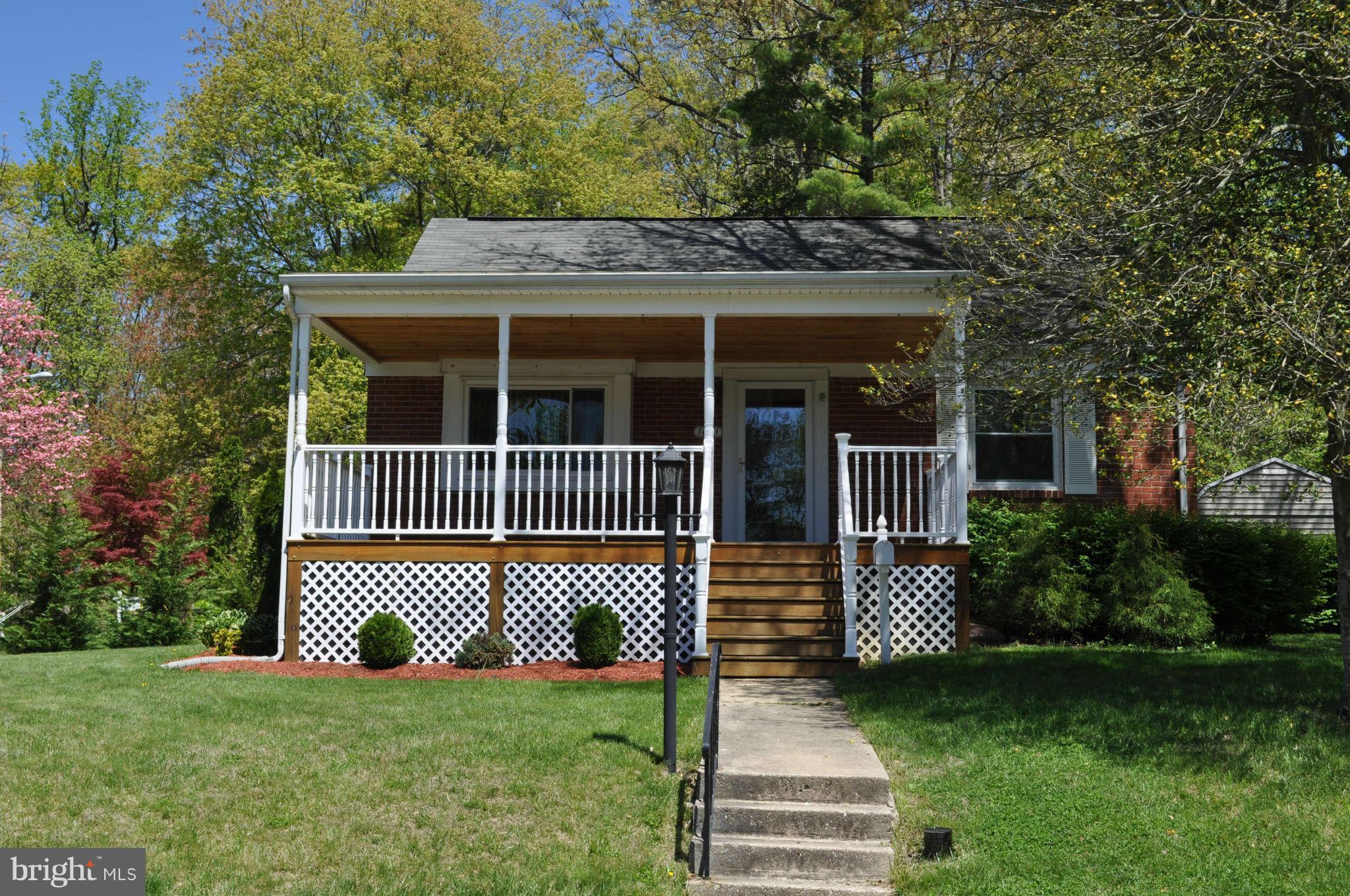a view of a house with a yard and fence