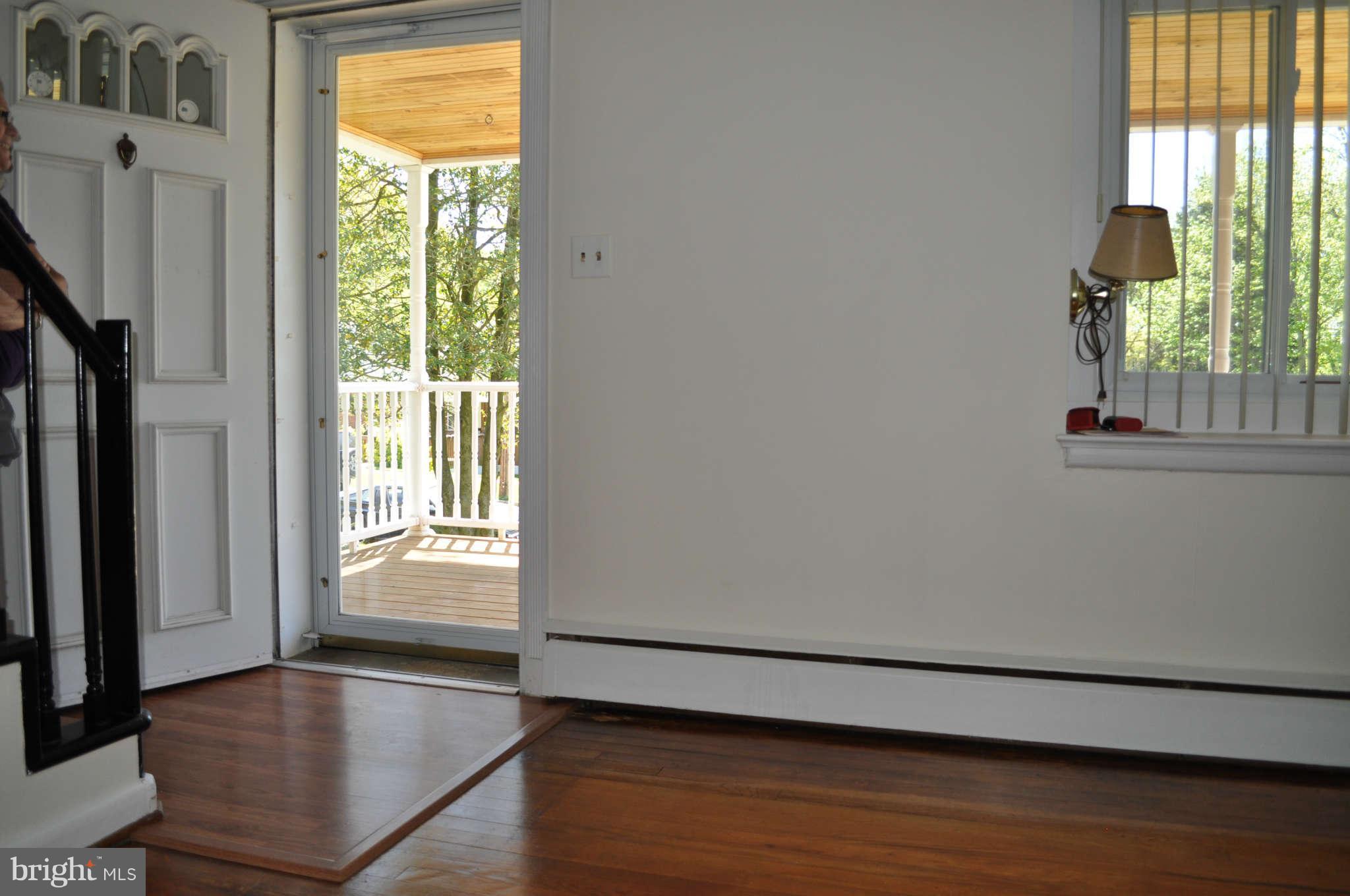 1021 Kingston Road Baltimore, MD 21208 - Photo 11 of 20 a view of an empty room with wooden floor and a window
